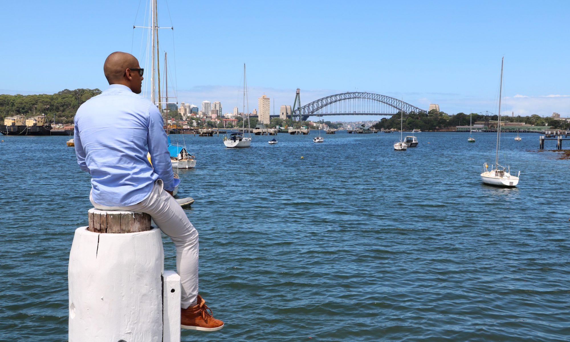 Mourad Tellab looking across Sydney Harbour towards the Harbour Bridge